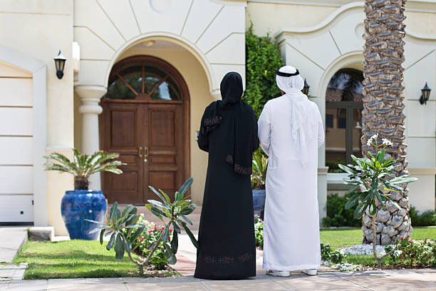 middle eastern couple looking their new home in dubai.