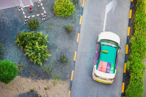 dubai, uae september 25 2018: taxi car waiting at the hotel. aerial view